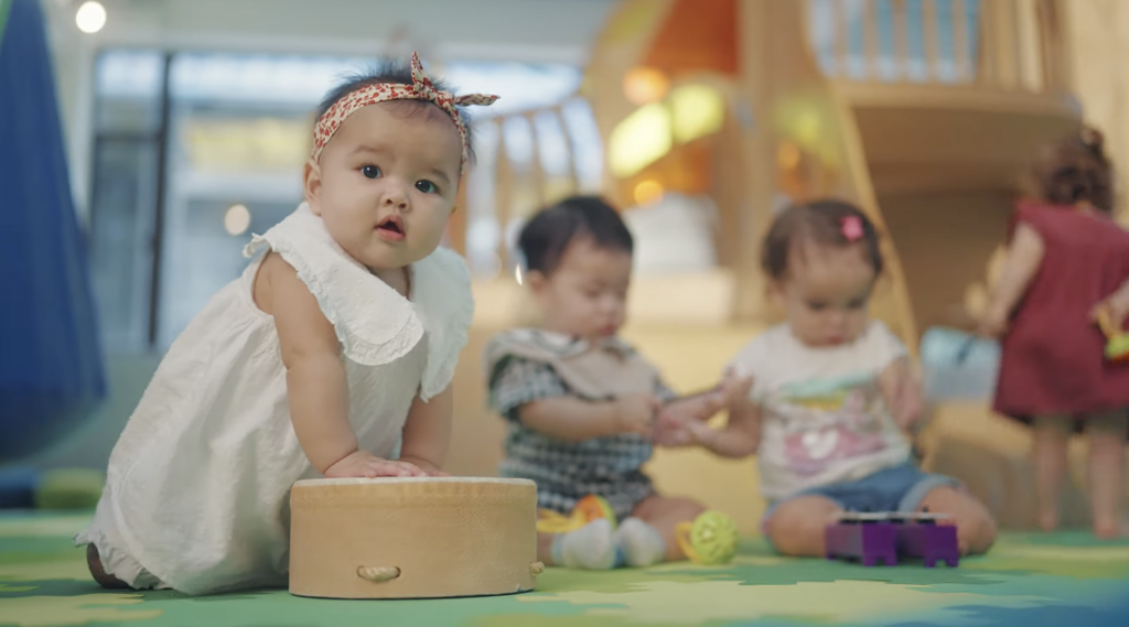 Young toddlers at Hong Kong Child music program Baumhaus explore instruments during class.